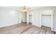 Bright bedroom with wood-look vinyl floors, ceiling fan, and ample closet space with bifold doors at 250 E 20Th Ave, Mount Dora, FL 32757