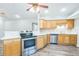 Kitchen showcasing stainless steel appliances, wood cabinets, breakfast bar, and modern design at 250 E 20Th Ave, Mount Dora, FL 32757