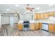 Modern kitchen features stainless steel appliances, light wood cabinetry, and a breakfast bar at 250 E 20Th Ave, Mount Dora, FL 32757