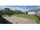 Spacious backyard with grass, a brick patio, and a black metal fence around the property at 3043 Beaver Creek Dr, Kissimmee, FL 34746