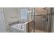 Bathroom featuring a tiled floor, soaking tub, and glass shower at 3043 Beaver Creek Dr, Kissimmee, FL 34746