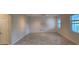 Bonus room with tile flooring, natural light, textured panel wall, and neutral color palette at 3043 Beaver Creek Dr, Kissimmee, FL 34746