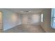 Bonus room with tile flooring, natural light, textured panel wall, and neutral color palette at 3043 Beaver Creek Dr, Kissimmee, FL 34746