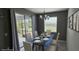 Modern dining room featuring a black table, contemporary lighting fixture, and sliding glass doors at 3043 Beaver Creek Dr, Kissimmee, FL 34746