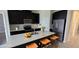 Modern kitchen featuring sleek black cabinets, stainless steel appliances, and a spacious island with seating at 3043 Beaver Creek Dr, Kissimmee, FL 34746