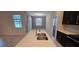 Close-up of the center island in the kitchen with modern fixtures and a dining area nearby at 3043 Beaver Creek Dr, Kissimmee, FL 34746