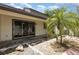 Relaxing backyard featuring a sliding door, lush palm trees, and decorative rock landscaping at 4060 E Maryland Pl, Casselberry, FL 32707