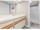 A bathroom with an extended vanity, sliding mirror, a separate door leading to a shower and vinyl flooring at 4060 E Maryland Pl, Casselberry, FL 32707