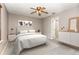 A bright and modern bedroom with a ceiling fan, calming wall art, and crisp white bedding at 4060 E Maryland Pl, Casselberry, FL 32707