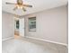 A light-filled room with neutral walls, carpet, a ceiling fan, and two windows with blinds at 4060 E Maryland Pl, Casselberry, FL 32707