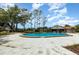 Inviting community pool features ample lounging space, mature trees, and a nearby covered pavilion at 4060 E Maryland Pl, Casselberry, FL 32707