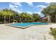 Large community pool with surrounding trees and lounge area, perfect for relaxation and recreation at 4060 E Maryland Pl, Casselberry, FL 32707