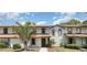 Charming condo featuring a well-manicured lawn, dark green front door and a healthy palm tree at 4060 E Maryland Pl, Casselberry, FL 32707