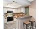 Efficient kitchen featuring bright white cabinets, modern stools, and stylish countertops at 4060 E Maryland Pl, Casselberry, FL 32707