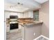 Efficient kitchen featuring bright white cabinets, modern appliances, and stylish countertops at 4060 E Maryland Pl, Casselberry, FL 32707