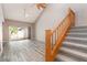 Cozy living room featuring high ceilings, wood floors, access to a patio, and carpeted stairs to the upper level at 4060 E Maryland Pl, Casselberry, FL 32707