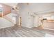 Open-concept living space featuring high ceilings, a staircase, wood floors and a view into the kitchen at 4060 E Maryland Pl, Casselberry, FL 32707