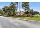 Welcoming neighborhood entrance with brick signage, mature trees, and well-maintained landscaping at 4060 E Maryland Pl, Casselberry, FL 32707