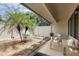 A serene outdoor patio area with comfortable seating, palm trees, and a well-maintained yard at 4060 E Maryland Pl, Casselberry, FL 32707