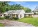 Single-story home featuring a charming exterior with beautiful landscaping at 407 Forest Rd, Mount Dora, FL 32757