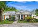 Quaint single-story house with a green front door and well-maintained landscaping at 407 Forest Rd, Mount Dora, FL 32757