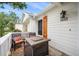 Inviting front porch with a cozy seating area featuring a modern fire pit, perfect for enjoying the outdoors at 407 Forest Rd, Mount Dora, FL 32757