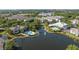 Picturesque aerial view showcasing community amenities: pools, clubhouse, and waterfront scenery at 5136 Park Central Dr # 212, Orlando, FL 32829