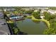 Scenic aerial view of the community pool, clubhouse, and tranquil pond at 5136 Park Central Dr # 212, Orlando, FL 32829