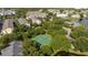 Overhead view of a tennis court surrounded by mature trees in a residential community at 5136 Park Central Dr # 212, Orlando, FL 32829