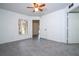 Bright bedroom featuring tile floors, a ceiling fan, and a window for natural light at 5136 Park Central Dr # 212, Orlando, FL 32829