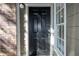 Solid front door and side window on a brick and siding exterior wall at 5136 Park Central Dr # 212, Orlando, FL 32829