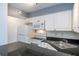 Efficient kitchen featuring white appliances, granite countertops, and ample cabinet space at 5136 Park Central Dr # 212, Orlando, FL 32829