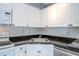 Close-up view of the kitchen sink, countertop, and white cabinetry at 5136 Park Central Dr # 212, Orlando, FL 32829