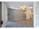 Open living room featuring tile flooring, a ceiling fan, and access to the kitchen at 5136 Park Central Dr # 212, Orlando, FL 32829