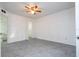 Bright main bedroom featuring tile floors, fan, and a convenient bathroom entrance at 5136 Park Central Dr # 212, Orlando, FL 32829