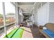 Covered outdoor patio features a mini-golf area, tables and chairs, and views of landscaped greenery at 5136 Park Central Dr # 212, Orlando, FL 32829