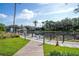 Scenic pond view with a charming gazebo and lush landscaping on a sunny day at 5136 Park Central Dr # 212, Orlando, FL 32829