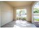 Bright sun room with wooden floors and large window with green outdoor view at 5136 Park Central Dr # 212, Orlando, FL 32829
