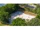 Overhead view of a sand volleyball court nestled among lush trees at 5136 Park Central Dr # 212, Orlando, FL 32829