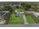 Expansive aerial view showcasing a well-maintained home with a large yard and detached garage at 8975 Cypresswood Dr, Lake Wales, FL 33898