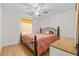 Cozy bedroom with wood floors, a metal frame bed, and bright natural light at 8975 Cypresswood Dr, Lake Wales, FL 33898