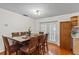 Dining room features wood floors, seating for eight, and access to the backyard through glass doors at 8975 Cypresswood Dr, Lake Wales, FL 33898