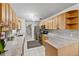 Bright kitchen with granite countertops, stainless steel appliances, and light wood cabinetry at 8975 Cypresswood Dr, Lake Wales, FL 33898