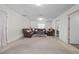 Spacious living room featuring a seating arrangement, neutral carpet, and natural light at 8975 Cypresswood Dr, Lake Wales, FL 33898