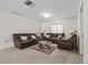 Comfortable living room featuring a seating arrangement, neutral carpet, and a glass coffee table at 8975 Cypresswood Dr, Lake Wales, FL 33898