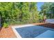 Outdoor patio area with lush greenery and mature trees offering natural privacy at 9516 Piccadilly Sky Way, Orlando, FL 32827
