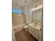 Bright bathroom features a shower and tub combination with modern vanity and light fixtures at 9516 Piccadilly Sky Way, Orlando, FL 32827