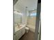 Bright bathroom features a tub and shower combo, single sink vanity, and wood-look flooring at 9516 Piccadilly Sky Way, Orlando, FL 32827