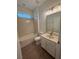 Bright bathroom featuring a white vanity, sink, tub/shower combo, and modern lighting fixture above the mirror at 9516 Piccadilly Sky Way, Orlando, FL 32827