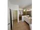 Bathroom features double sink vanity, glass-enclosed shower, and tiled floors at 9516 Piccadilly Sky Way, Orlando, FL 32827